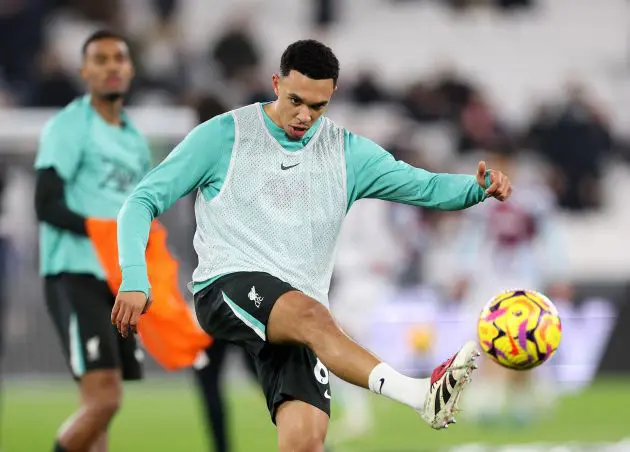 Trent Alexander-Arnold kicks a ball during a pre-West Ham warmup.