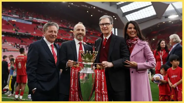 Liverpool owner John W Henry holds the Premier League trophy with Mike Gordon.