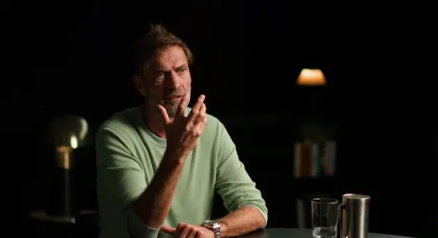 Jurgen Klopp gestures with one hand in a sit down interview.