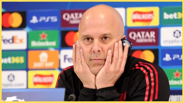 Arne Slot holds his head in both hands during Liverpool presser.
