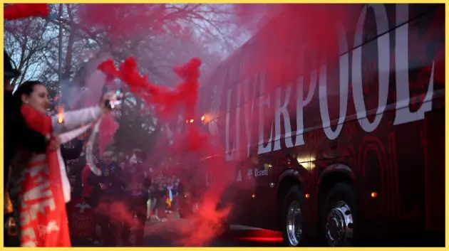 Liverpool fans set off flares as the team bus passes