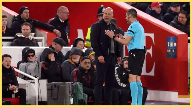 Referee Maurizio Mariani speaks with Arne Slot, Manager of Liverpool, after he attempts to control the ball which was still in play during the UEFA Champions League 2025/26 Quarter-Final Second Leg match between Liverpool FC and Paris Saint-Germain FC at Anfield