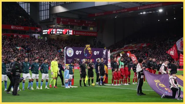 Players line up in front of Premier League With Pride branding during the Premier League match between Liverpool and Manchester City at Anfield