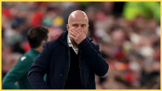 Arne Slot covers his mouth with his hand during Liverpool game.